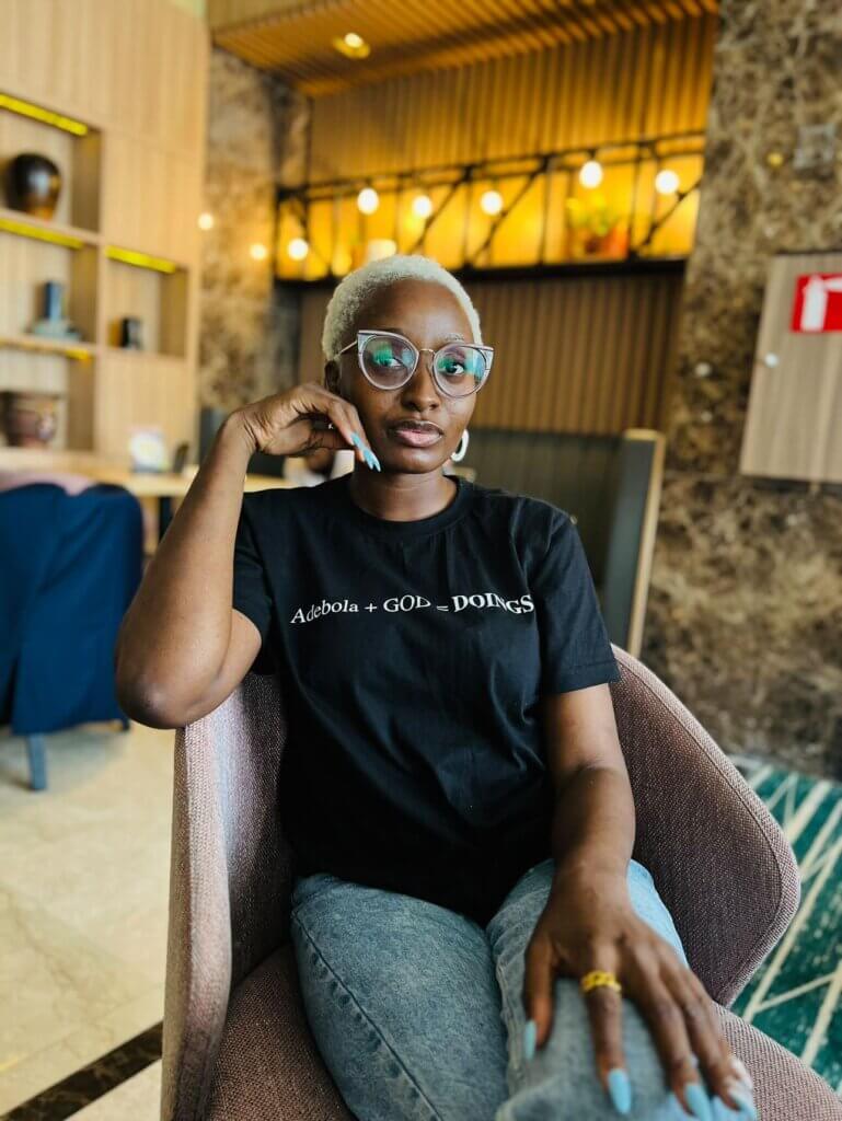 Adebola Williams on Revamping Your Personal Brand for 2023: Expert Insights and Actionable Tips A picture of Adebola Zoe sitting with her leg crossed